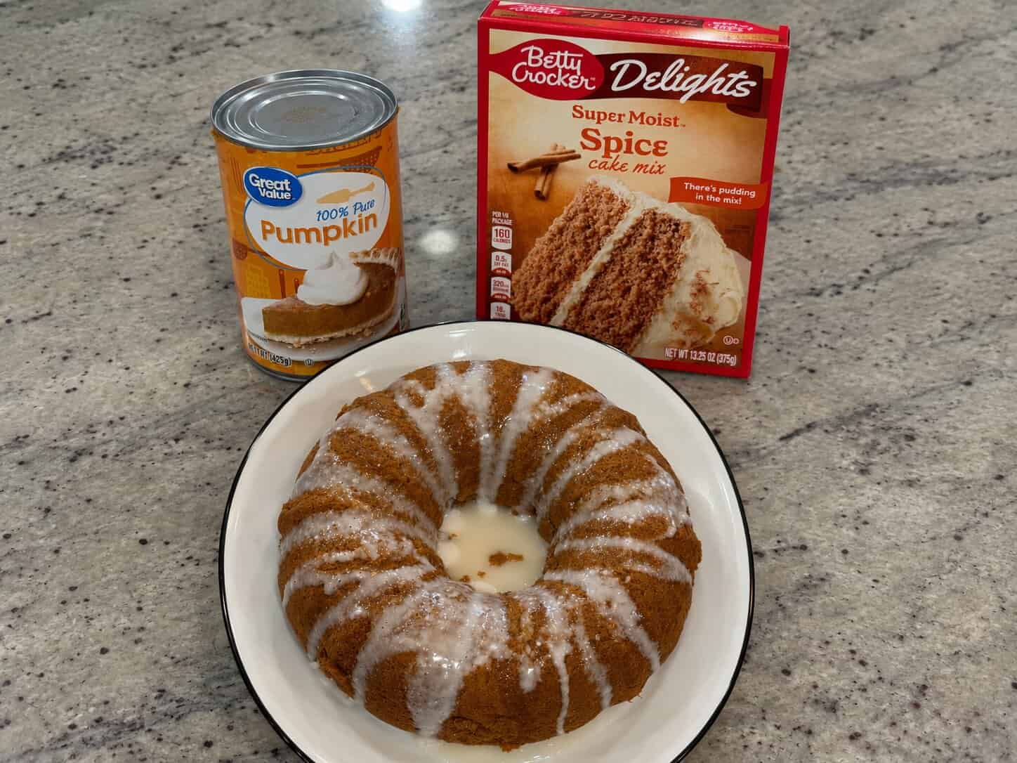Easy pumpkin spice cake made with spice cake mix and topped with powdered sugar glaze